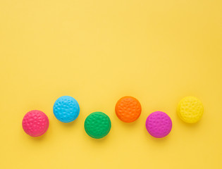 Row of colorful macarons on yellow background. Top view, Funny background concept.