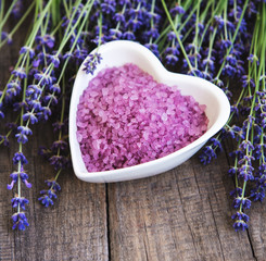 Heart-shaped bowl with sea salt  and fresh lavender flowers