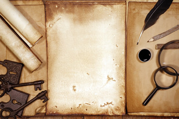 Vintage writing set with old paper on brown wood texture with feather and ink