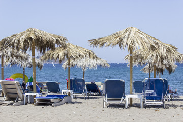 Perspective shot of blue sunbeds near open sea at Petra in Lesvos