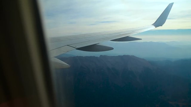aircraft flies over the mountains