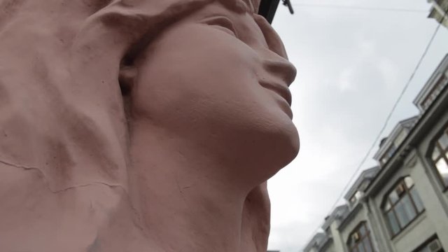 Sculpture of the woman face on the wall of an old house in St. Petersburg