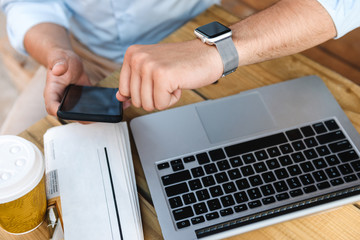 Close up of a businessman checking his smartwatch