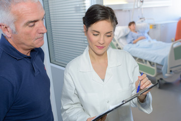 nurse checking with senior patient results