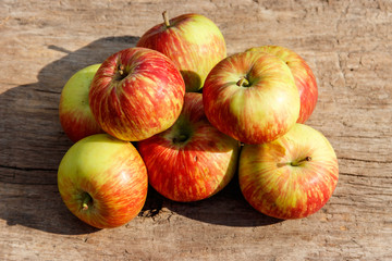 Fresh ripe apples on rustic wooden table