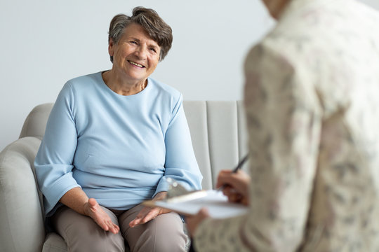 Elderly woman talking with financial advisor about loan during appointment