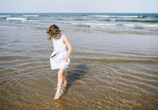 Little girl walking in the water