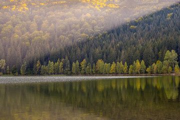 Fototapeta na wymiar Autumn landscape. Saint Ana lake in Romania, the only volcanic lake in Europe, formed in a crater of a dead volcano