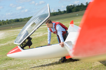 Man standing next to glider