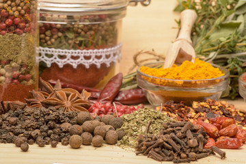 Various spices on wooden background.
