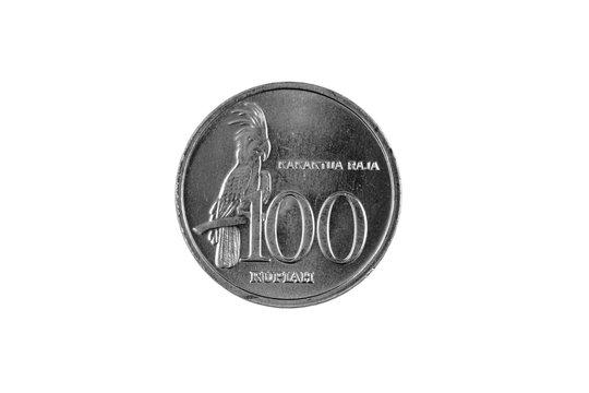 An extreme close up of an Indonesian 100 rupiah coin on a solid white background