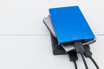 External disk hard drive connected to notebook for backup from computer data on white background