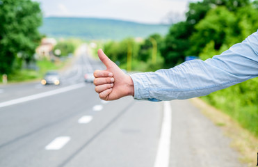 Thumb up gesture meaning. Cultural difference. Hitchhiking gesture. Thumb up inform drivers...