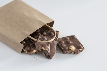 healthy hazelnut chocolate with paper bag on the white background for cafe or shop concept. 