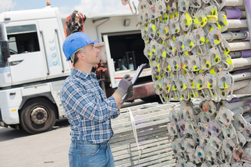 Man noting color coded scaffold poles