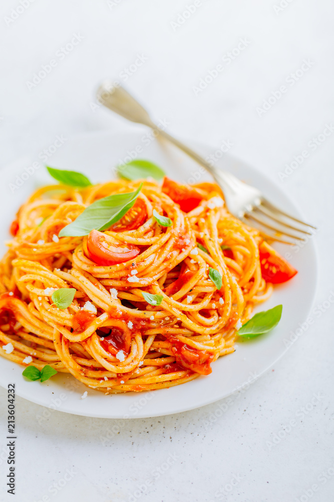 Wall mural Pasta dish with tomato sauce on white plate