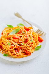 Pasta dish with tomato sauce on white plate