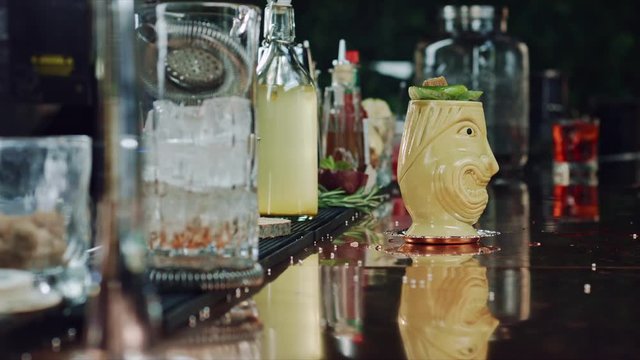 The bartender sets the cocktail on fire