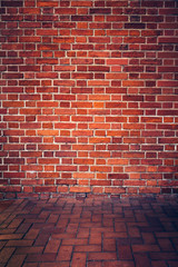 Retro red brick wall and brick floor.