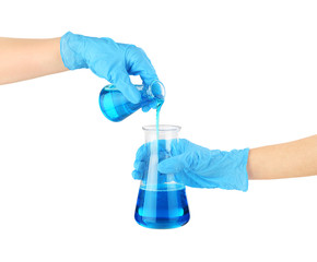 Hands in medical gloves and flasks with reagents