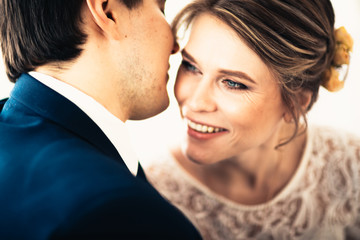 couple groom and bride near the window