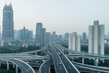 aerial view of buildings and highway of shanghai city in smoggy dawn