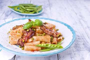 Pasta with fresh green peas. Traditional food. Oriental dishes. White wooden background. Healthy food. Diet. Free space for text