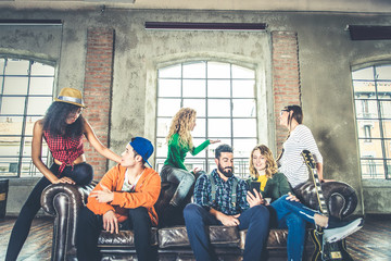 Friends having fun on the sofa at home