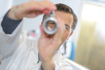 ophthalmologist examines the eyes with handheld lense