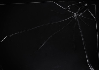 A broken glass on a dark surface, with many sharp shards. Useful texture overlay.

