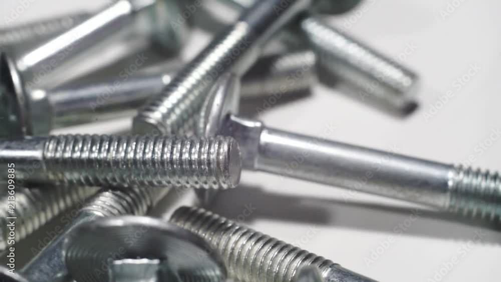 Poster bolts rotating on a white wooden table background. macro view,
