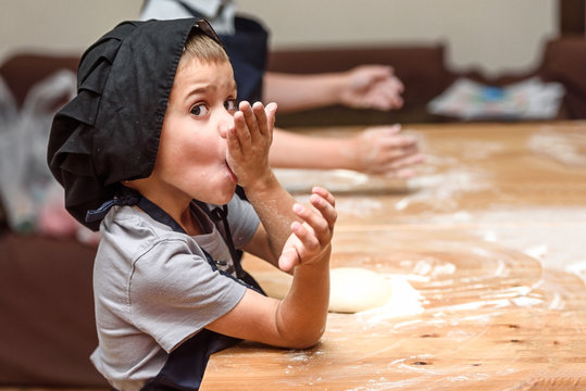 Pizza, children and the concept of cooking - children make pizza.