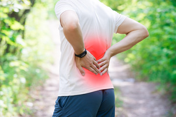 Man with back pain, injury while running, trauma during workout