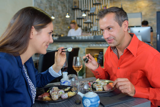 Couple sharing sushi meal