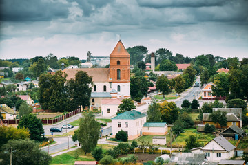 Fototapeta na wymiar Mir, Belarus. Landscape Of Village Houses And Saint Nicolas Roman