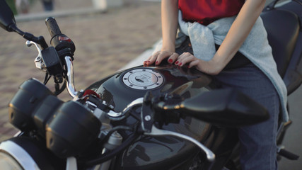 Fototapeta na wymiar beautiful young red-haired woman motorcyclist with black motorcycle helmet