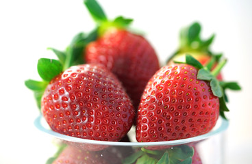 Macro closeup of bowl of fresh strawberries.
