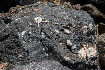 The surface of an old rock with cracks. Old rock texture (wild background).