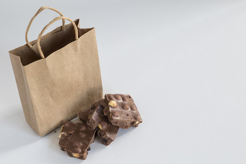 healthy hazelnut chocolate with paper bag on the white background for cafe or shop concept. 