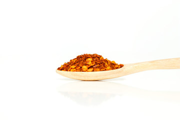 cayenne pepper spoon on white background