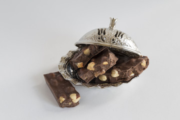 healthy hazelnut chocolate in the copper plate on the white background for cafe or shop concept. 
