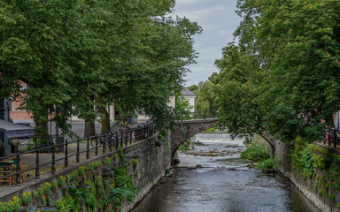 Fototapeta na wymiar A calm canal with a bridge in Uppsala, Sweden