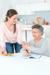 Obraz na płótnie Canvas young carer helping senior lady