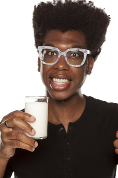 Portrait of young african american man holding glass with yogurt on white background