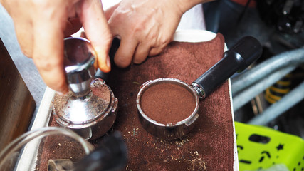 Portafilter and Tampering coffee with hand.To making fresh coffee.