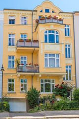 Fototapeta na wymiar facade with balconies and flower beds