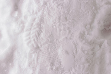 Obraz premium Footprints of people's shoes in the snow