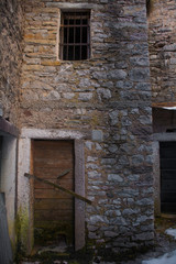 A door in an abandoned building in the hill village of Casso in winter Friuli Venezia Giulia, north east Italy. 