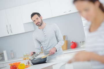 Husband cooking for his wife