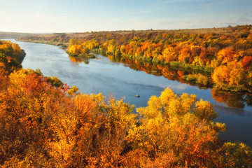View to wide and peaceful river, colorful fall season landscape